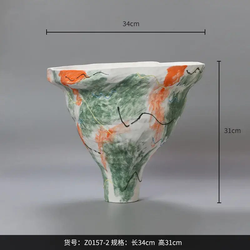 A handcrafted ceramic vase with an abstract irregular pattern of green orange and black for living room decor