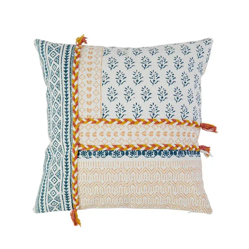 Boho style cotton patchwork pillow cover in cream and mustard with blue prints and orange braided trim by decorbites