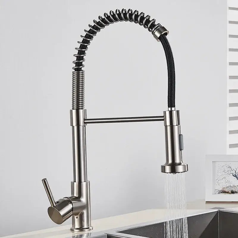 Brushed gold kitchen faucet with flexible coiled spring hose and stainless steel pull-down spray head for easy use