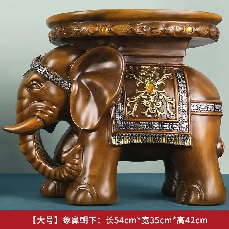 Brown carved wood elephant wealth attracting stool with ornate gold and silver embellishments and decorative saddle design