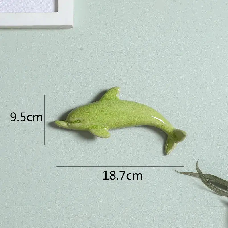 Glossy light green ceramic dolphin fish ocean wall decoration 9.5cm tall 18.7cm long decorbites dolphin fish for kids room