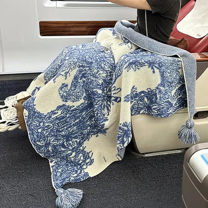 Cozy chinese ink blue and white toile knit blanket with cream tassels featuring traditional landscape decorbites cozy chinese