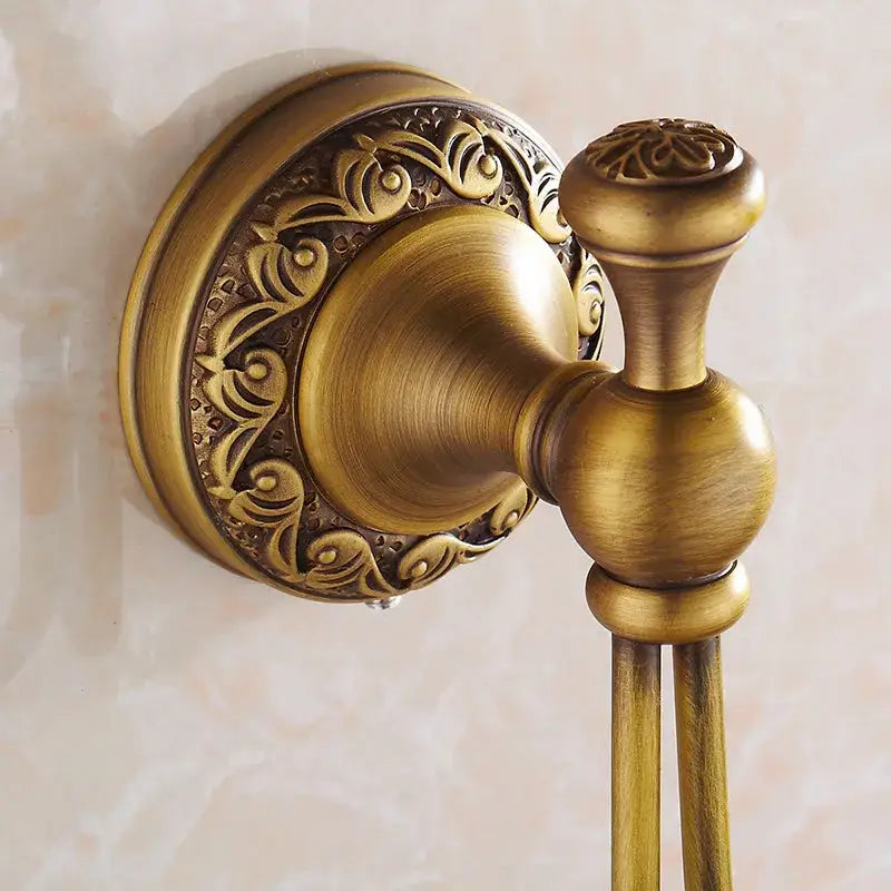Antique brass robe hooks by decorbites with ornate floral detailing and vintage-inspired design for bathroom use