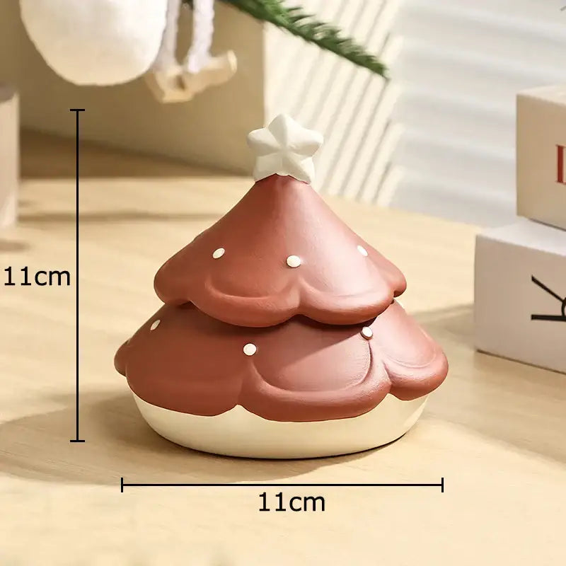 A terracotta décorBites christmas tree ceramic ashtray with white star topper and dots measuring 11cm square