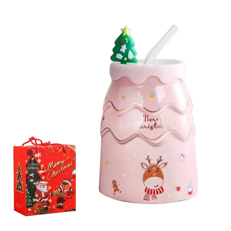 Pink ceramic decorbites christmas tree mug with wavy frosting design and festive reindeer and gingerbread illustrations