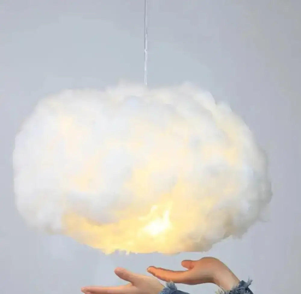 A soft fluffy white cloud led pendant light with warm pale yellow glow by decorbites for bedroom decor