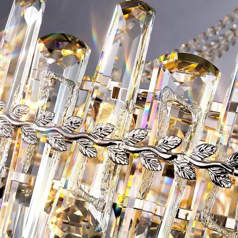 DecorBites crystal chandelier with tall clear prisms golden accents silver leaf motif for modern luxe home decor