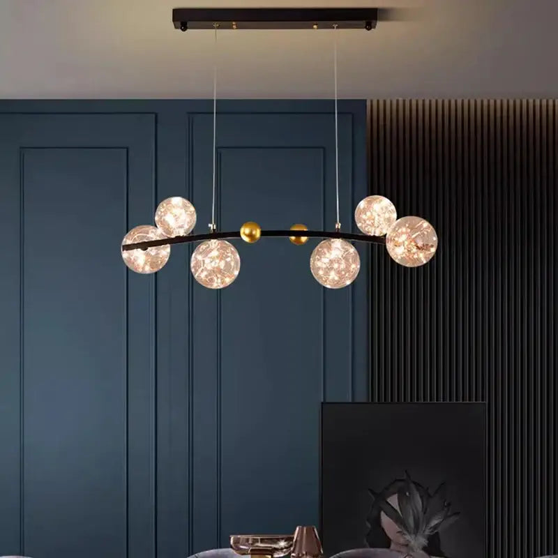 Modern black metal DecorBites LED pendant light chandelier with five frosted glass globes and gold accent spheres for indoor use