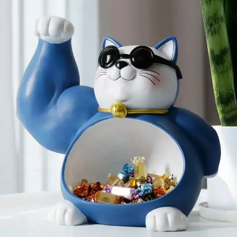 Blue and white resin lucky cat remote control figurine with black sunglasses gold collar and raised muscular arm for home decor
