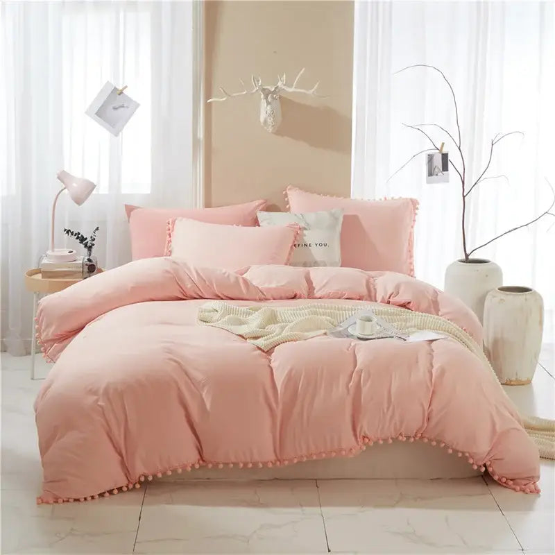Pink quilted duvet set with pom-pom trim from decorbites luxe furball tasseled bedding set for queen and king size beds