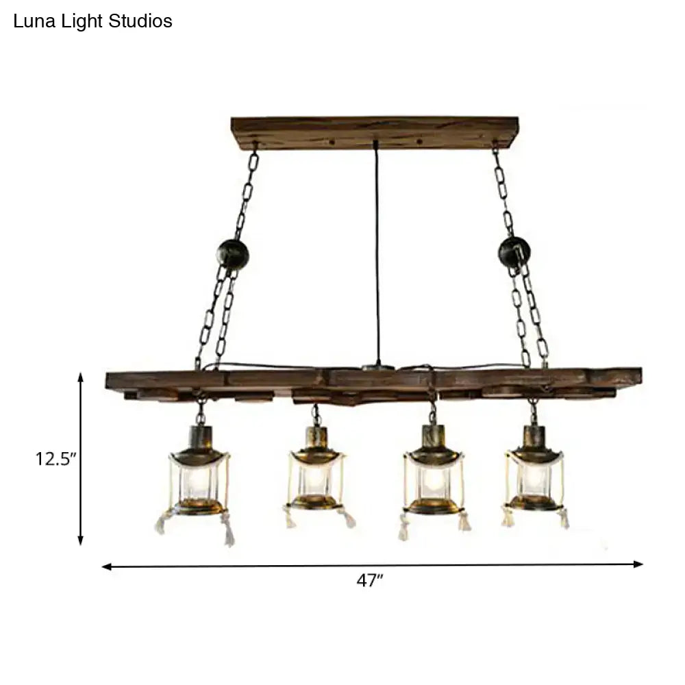 Rustic dark wood island lamp with four brass lantern-style lights and black metal chains for vintage decor
