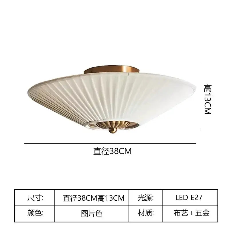 A decorbites french style ceiling lamp with white pleated fabric shade and brass metal accents for bedroom decor