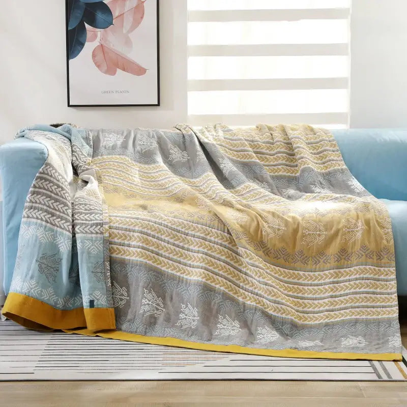 Geometric mustard and gray cotton gauze summer blanket featuring wavy stripes and white botanical motifs for decorbites cotton gauze decor