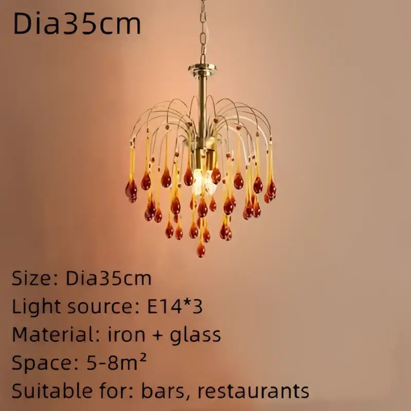 A brass-finished chandelier with cascading amber and clear crystal water drop beads for dining room lighting