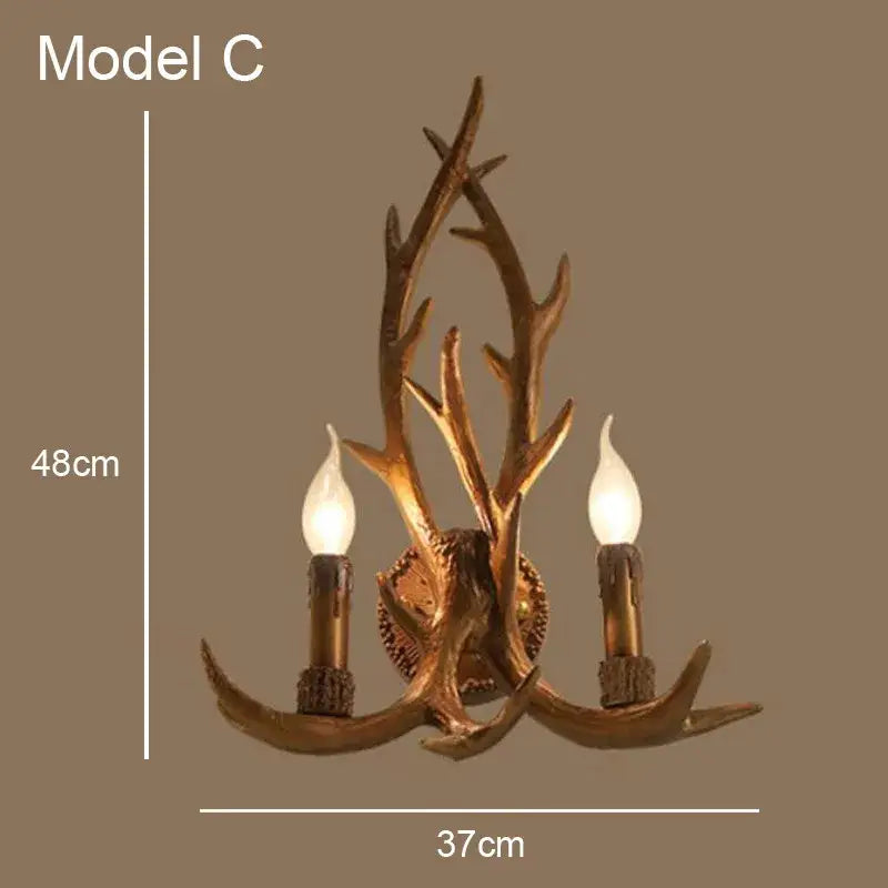 Golden antler deer horn wall lamp with two candle-style bulbs in golden-brown metallic finish for decorbites deer horn decor