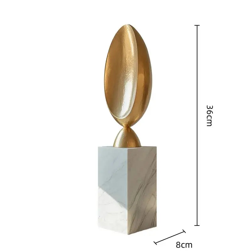 Golden geometric tree hole sculpture with a golden metallic egg shape mounted on white marble base for decorbites decor