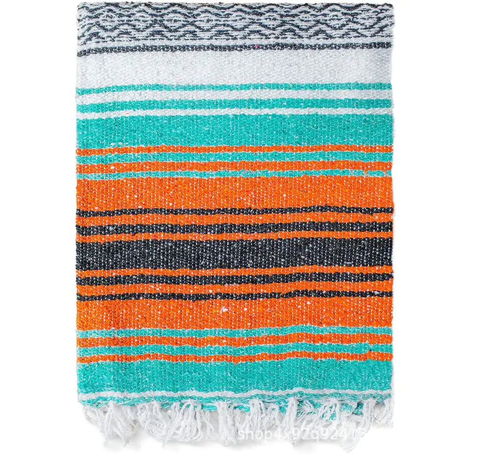 A decorbites handwoven mexican blanket with bold teal orange black stripes and white fringe ideal for bedroom decor