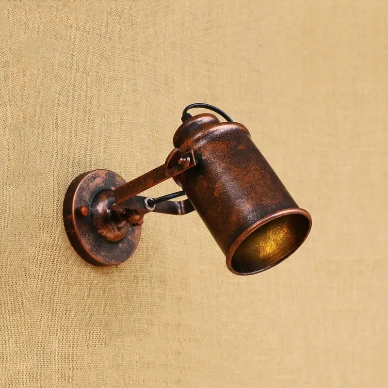Antique bronze-finished industrial-style wall light with cylindrical shade and adjustable arm for vintage wall decorbites industrial vintage decor