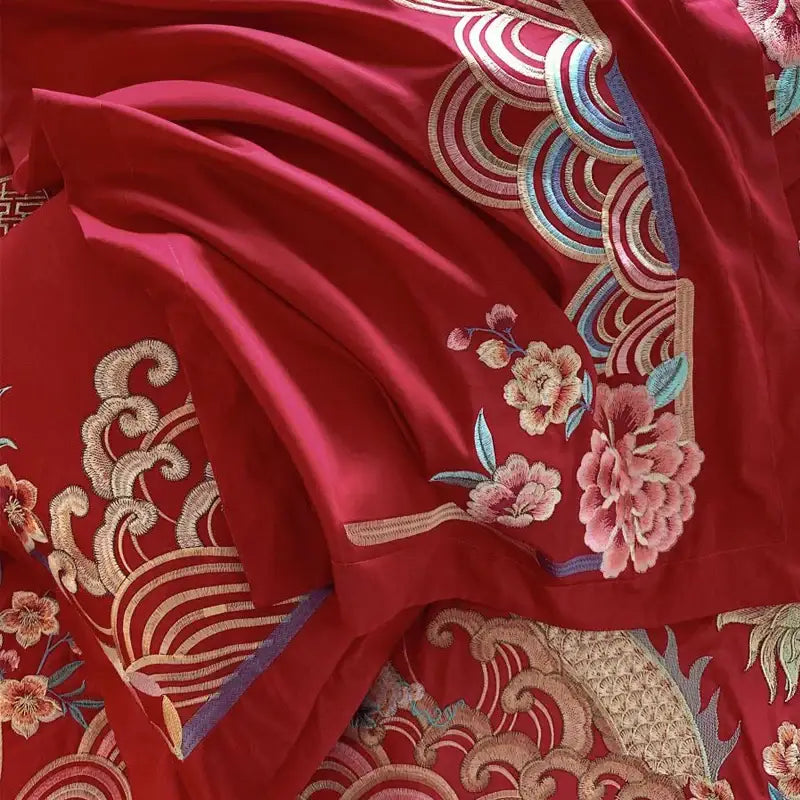 Luxurious red gold loong phoenix bedding set featuring rich crimson silk fabric with intricate gold pink blue floral embroidery