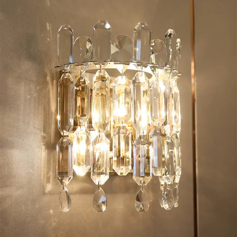 Luxury crystal wall lamp with faceted clear glass prisms and dangling teardrop crystals for elegant decorbites crystal wall decor