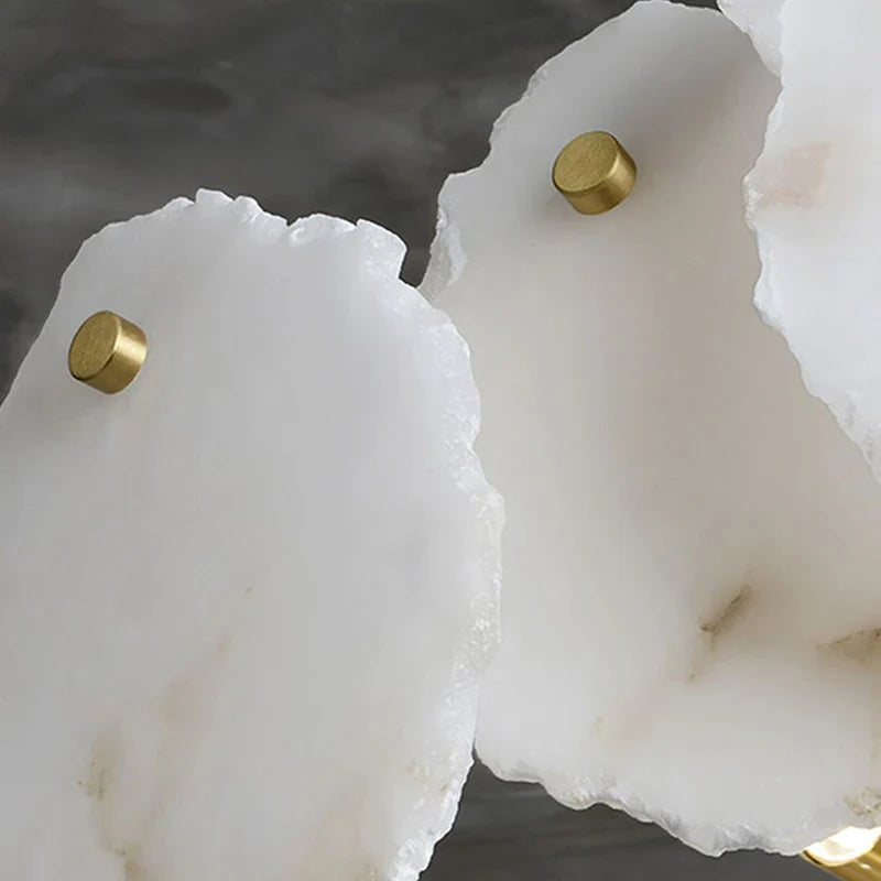 White agate slab coasters with gold-toned knobs displayed alongside marble led chandelier round pendant light