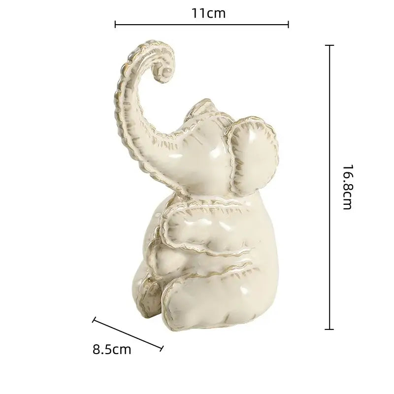 Cream-colored ceramic elephant figurine with glossy finish and textured features for home decor and decorbites elephant abstract
