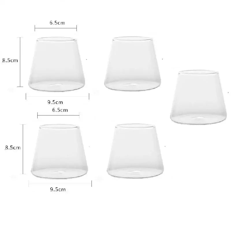 Minimalist clear glass water cup with tapered conical shape and smooth surfaces for kitchen and dining room use