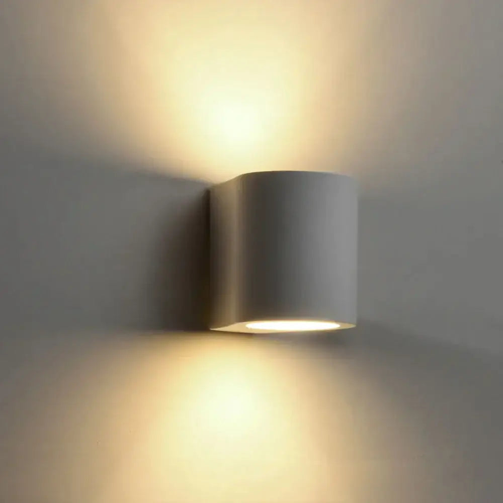 Minimalist white and gray gypsum wall lamp with warm focused light beam for living room wall lighting