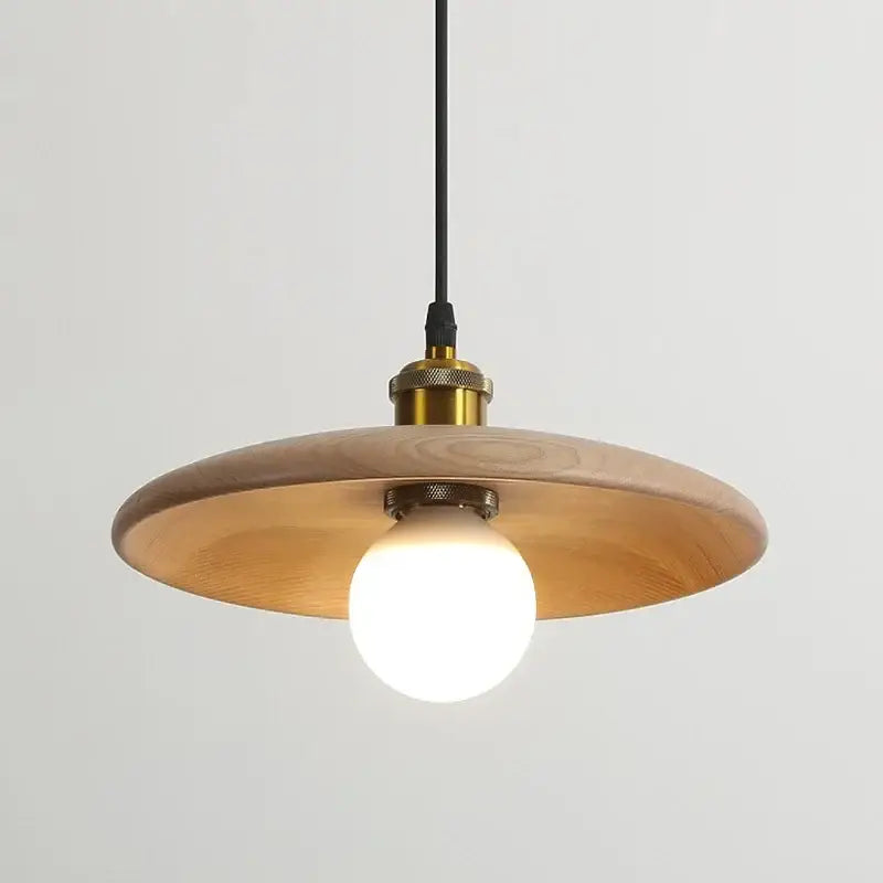 Minimalist wood and brass pendant light with warm-toned disc shade black cord and led bulb with three-color dimming