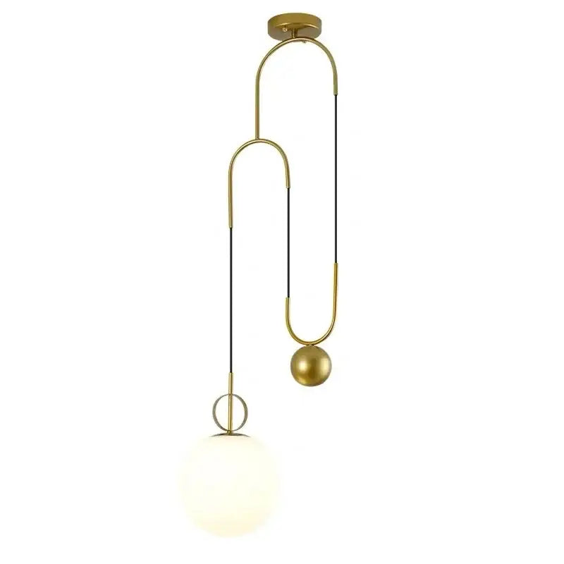 Modern brass glass ball pulley pendant light with gold-toned curved metal frame and opaque white glass globe shade