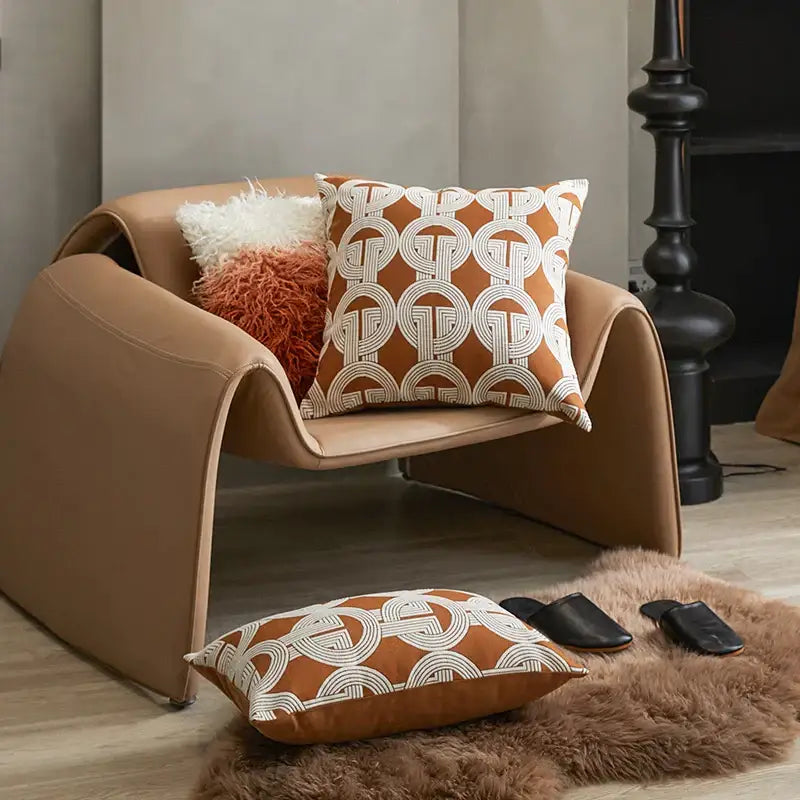 Tan leather armchair with sleek curved design complementing decorbites brown coffee geometric cushion cover for living room decor