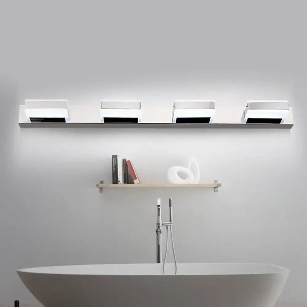 Modern chrome square acrylic vanity light fixture with four white rectangular fixtures in a row emphasizing fixture height