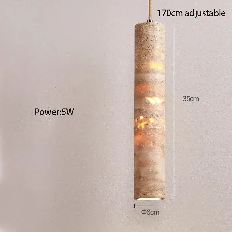Modern cream concrete cylindrical pendant light with textured finish and warm amber light source for dining room lighting area