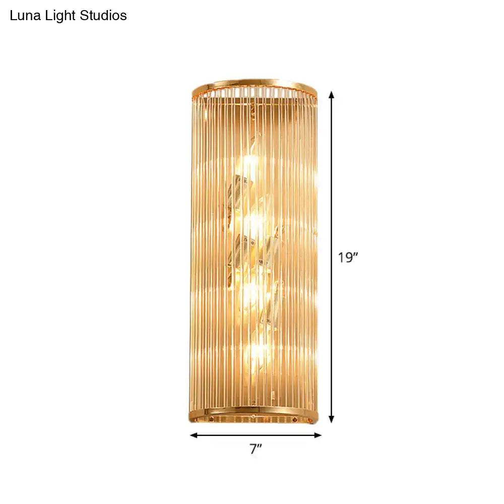 Modern gold cylinder wall mount lamp featuring vertical crystal rods and warm glowing light for hallway use