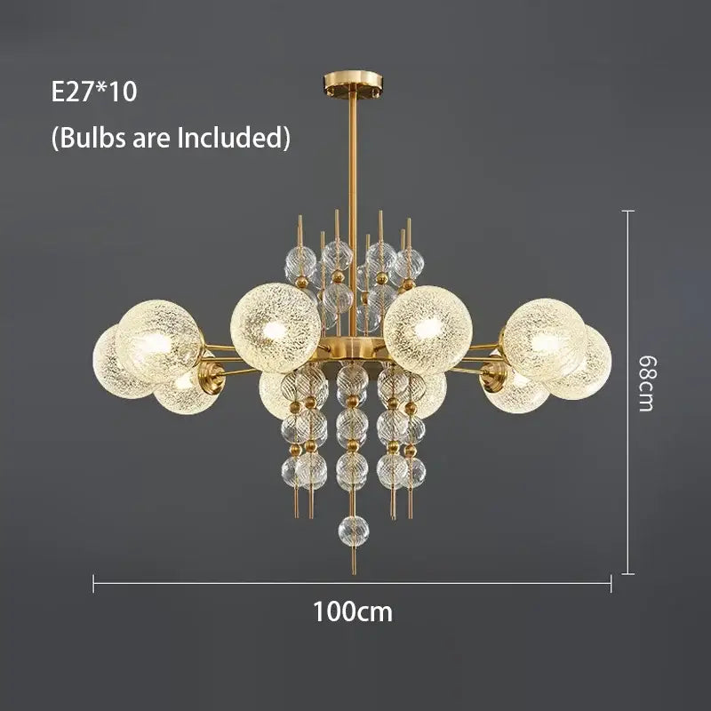 Modern gold glass ball pendant chandelier with ten frosted glass globe bulbs and clear crystal accents for kitchen island