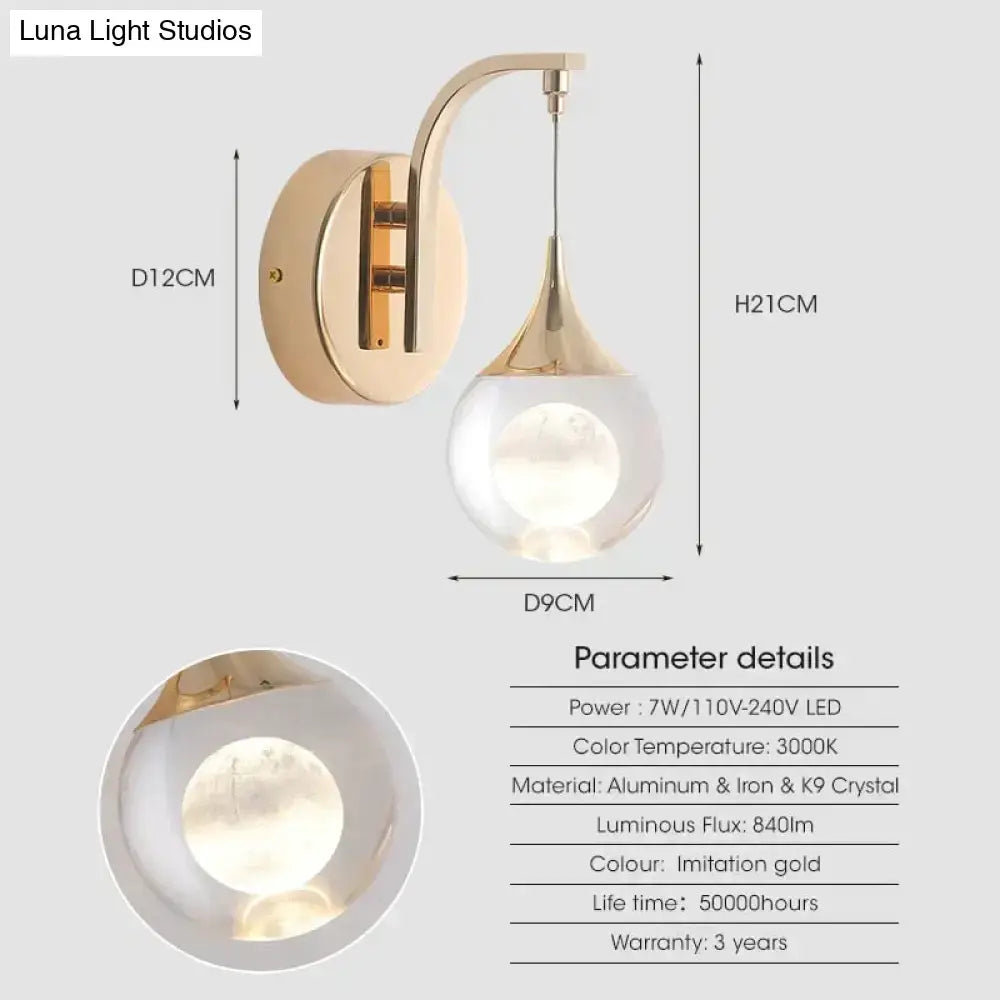 Modern luxurious crystal led wall sconce with gold curved metal arm and teardrop glass globe for bedroom lighting