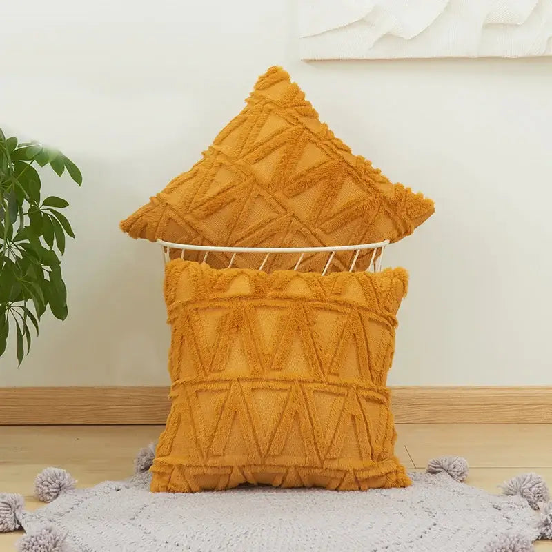 Warm mustard-yellow cushion cover with textured geometric pattern and fringed edges for modern living room decor