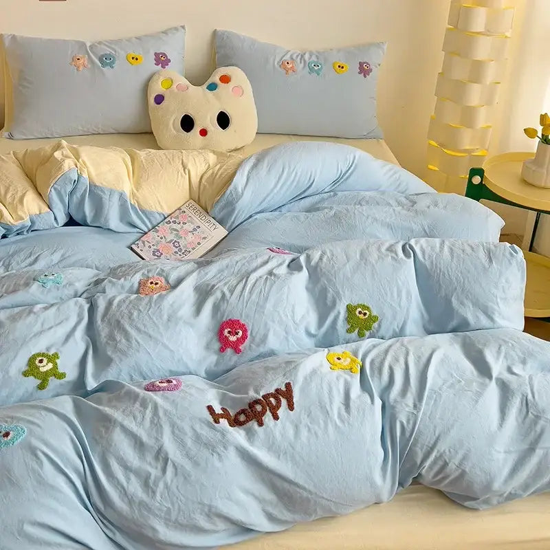 Light blue quilted duvet bedding set with colorful cartoon towel embroidery and brown happy text decorbites cartoon towel design