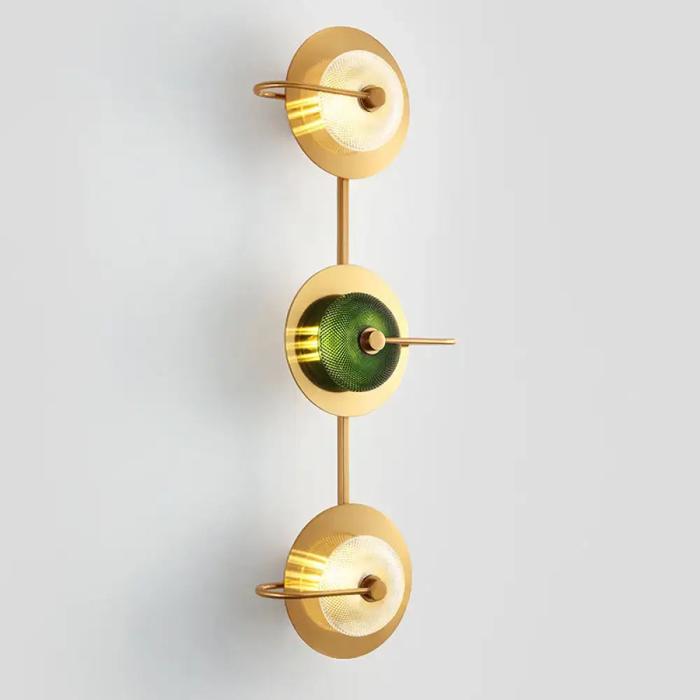 Postmodern gold wall sconce with three glass disc shades in clear and olive mounted lamp with brass rods for living room