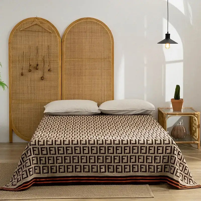 Beige and black geometric patterned decorbites cotton throw blanket with bold orange border for living room decor
