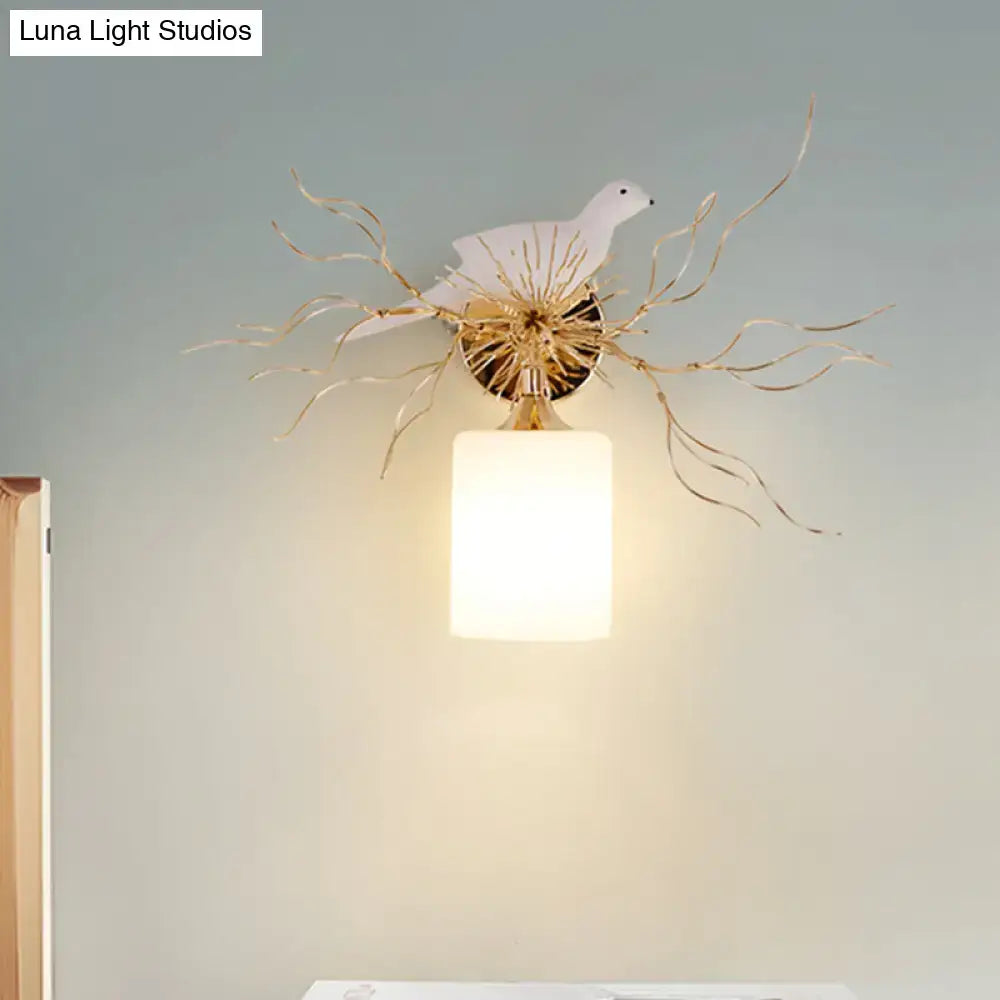 White glass bird wall lamp with led features a white ceramic dove on a gold branch with an illuminated frosted shade for bedroom