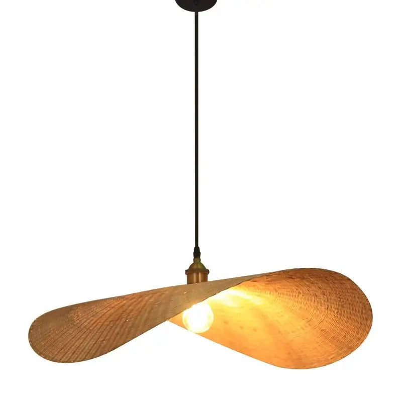 A warm-toned handwoven rattan bamboo zen tea pendant light with black cord and brass accent for tea room chandelier