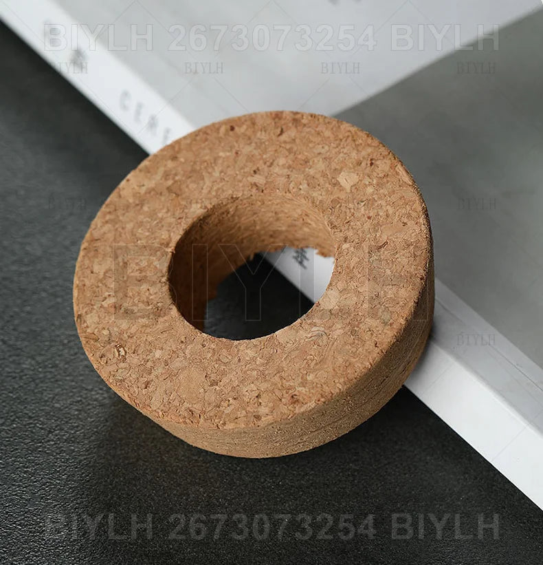 Natural brown cork stopper with textured porous surface and central hole for hydroponic glass flower pots base tray