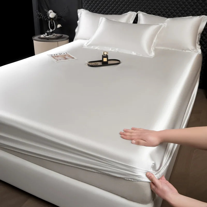 A sleek white 3 pcs mulberry silk sheet set with satin finish fitted sheet featuring elasticized edges for luxury comfort