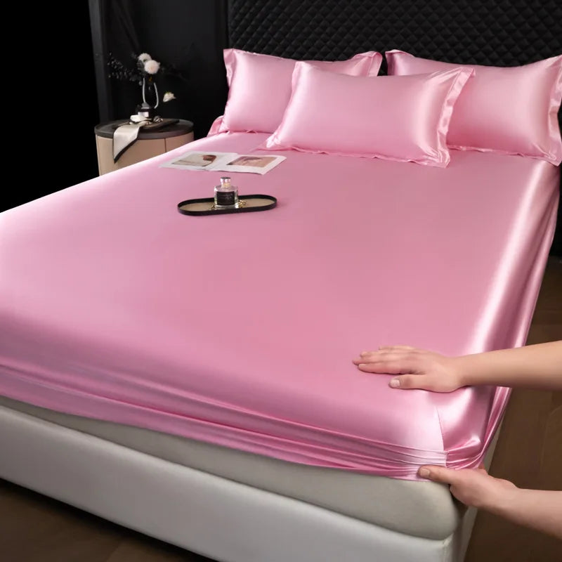Pink satin fitted sheet set with matching pillows made of 100 percent mulberry silk for luxury bed linen