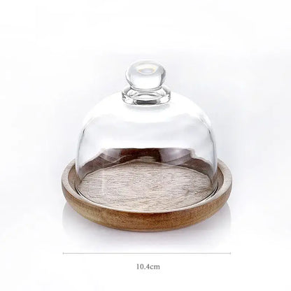 Clear glass dome with rounded knob handle resting on a wooden base for 3 tier glass food storage containers kitchen organizer