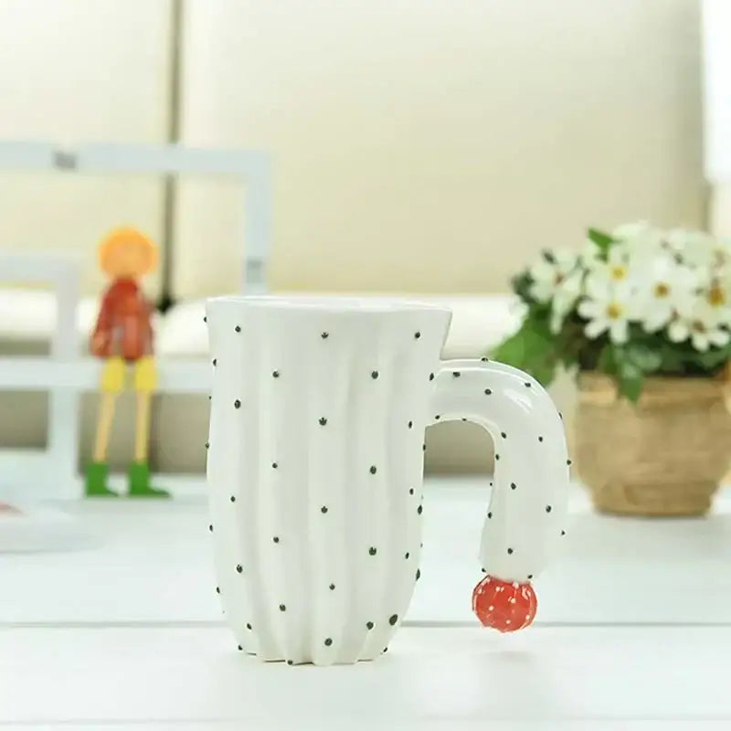 White ceramic decorbites 3d cactus style ceramic mug with black dot details and red strawberry accent handle