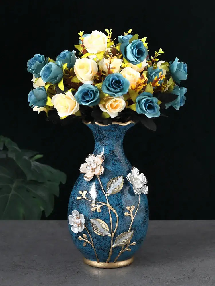 Blue ceramic vase with gold accents and white floral embellishments for dried flowers and wobble plate display