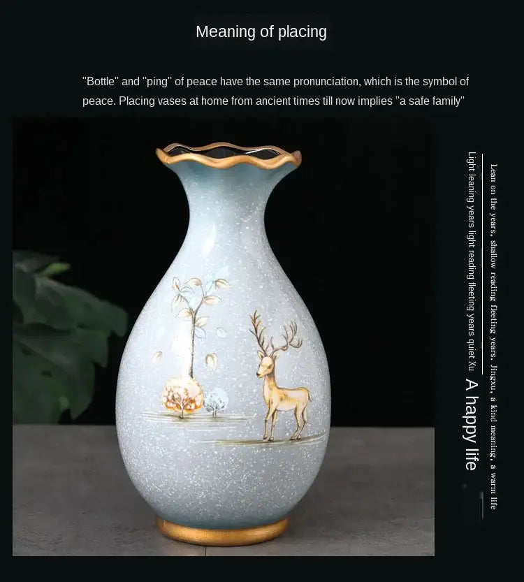 A light blue ceramic vase with gold rim and hand-painted deer and floral design ideal for dried flowers display