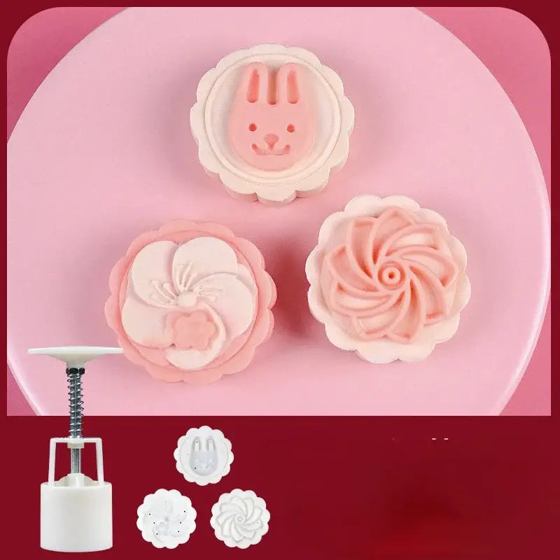 Set of three pink and white silicone cherry blossom mooncake molds with bunny flower and spiral designs for kitchen baking